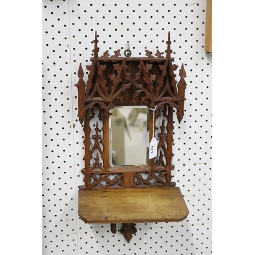 671 - Fine carved pierced timber mirror, with fold-up ledge, approx 46cm H x 23cm W