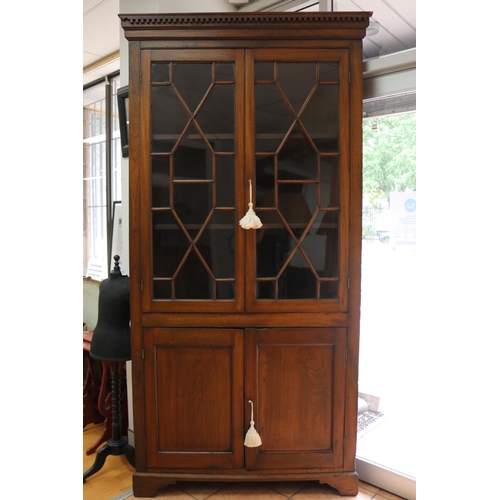 234 - Antique Georgian cedar two height corner cabinet, astral glazed two door top, recessed paneled two d... 