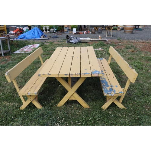 102 - Garden table and two benches, yellow painted, table approx 181cm L x 88cm W x 70cm H