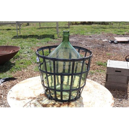 206 - Large antique French green glass wine bottle and metal basket, approx 67cm H
