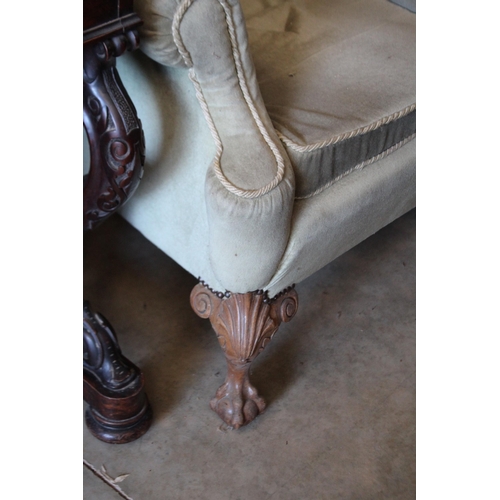 329 - English Georgian style wing arm chair, with carved claw and pearl feet.