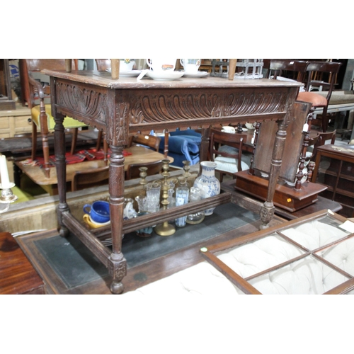 495 - Antique English oak side table, with carved front apron, turned legs joined by a stretcher below, ap... 