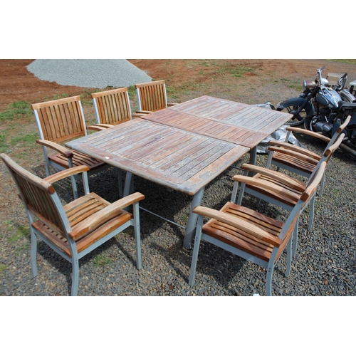 203 - Teak and aluminium extension out door table and matching set of seven arm chairs