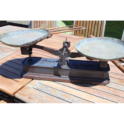 63 - Large set of antique French cast iron based balance scales with copper pans, approx 87cm W