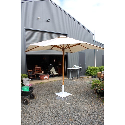 106 - Large Made in shade garden umbrella and weighted stand, Good sound condition no tears, 3 m square op... 