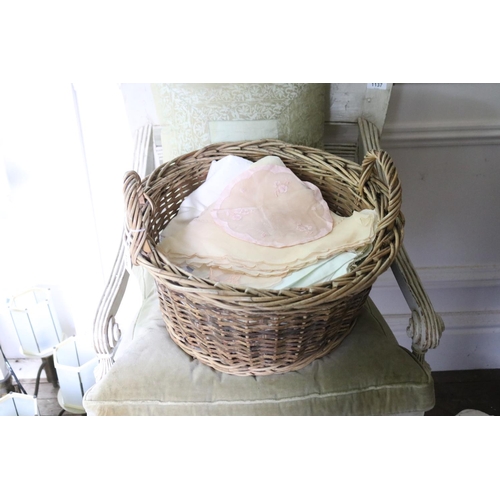 1108 - Twin handled cane basket, with assorted linen, approx 33cm H including handles x 45cm Dia