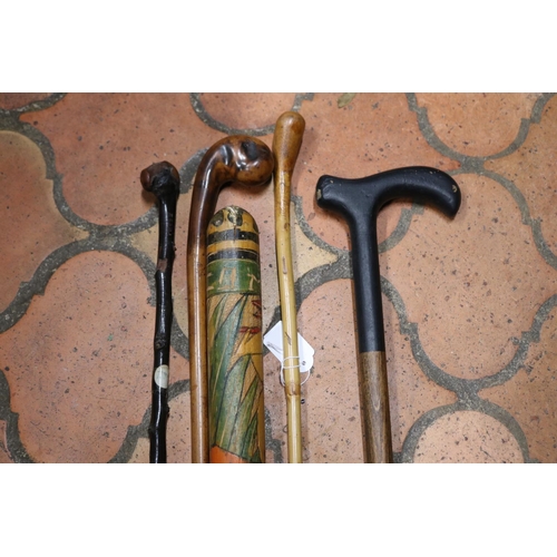 1164 - Mexican poker work pinata club, walking stick, cane ladies crop & two others, approx 107cm L and sho... 