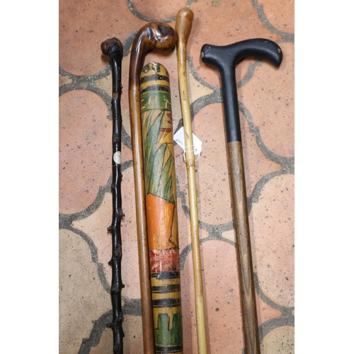 1164 - Mexican poker work pinata club, walking stick, cane ladies crop & two others, approx 107cm L and sho... 