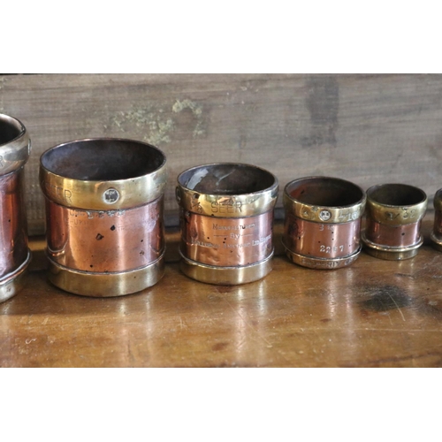 1116 - Set of six antique graduating copper and brass measures, manufactured by the lallubhai Amichand Ltd ... 
