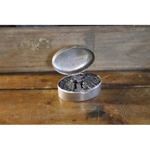 1214 - Vintage chrome oval box with metal stamps, approx 4cm H x 8cm W
