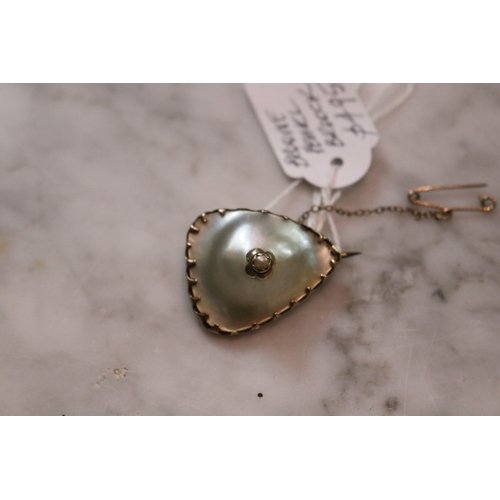 1269 - Antique blister pearl and gold brooch with safety chain with a central seed pearl, approx 3.5cm