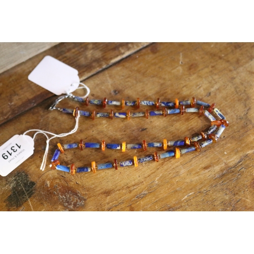 1319 - Lapis and amber necklace with beaten silver clasp, approx 73cm L