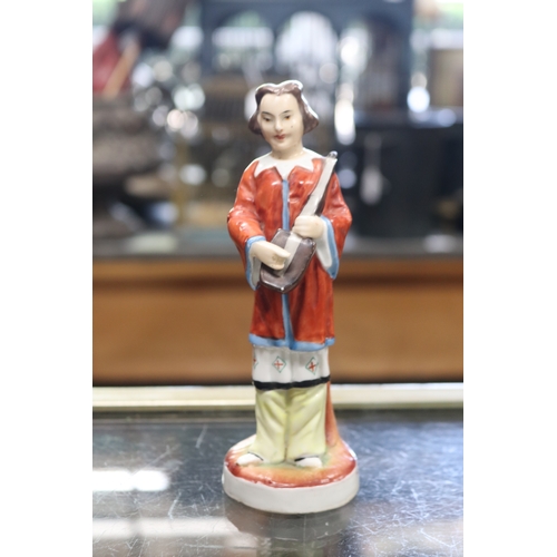 1354 - Antique European porcelain figure of a Chinese man, with long platted hair. Holding a musical instru... 