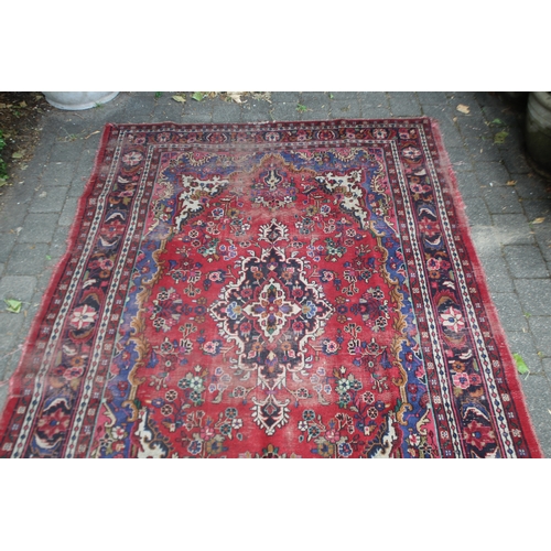 2587 - Distressed condition red ground carpet, approx 322cm L x 211cm W