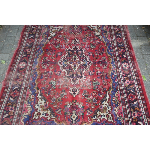 2587 - Distressed condition red ground carpet, approx 322cm L x 211cm W