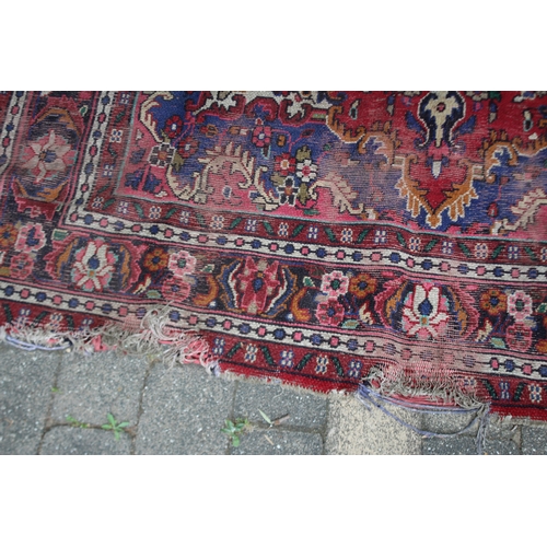 2587 - Distressed condition red ground carpet, approx 322cm L x 211cm W