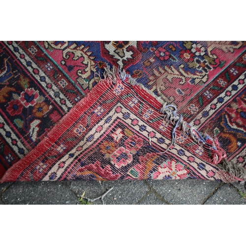 2587 - Distressed condition red ground carpet, approx 322cm L x 211cm W