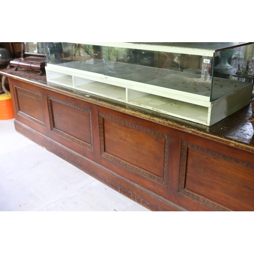 2591 - Antique silky oak and pine long shop counter, four recessed panel front, approx 85cm H x 374cm L x 7... 