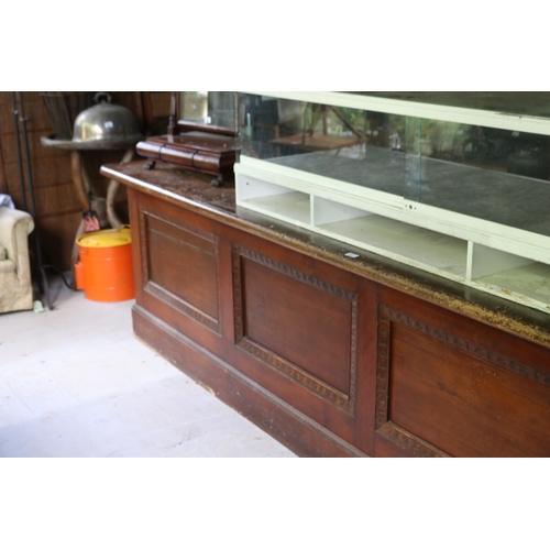 2591 - Antique silky oak and pine long shop counter, four recessed panel front, approx 85cm H x 374cm L x 7... 
