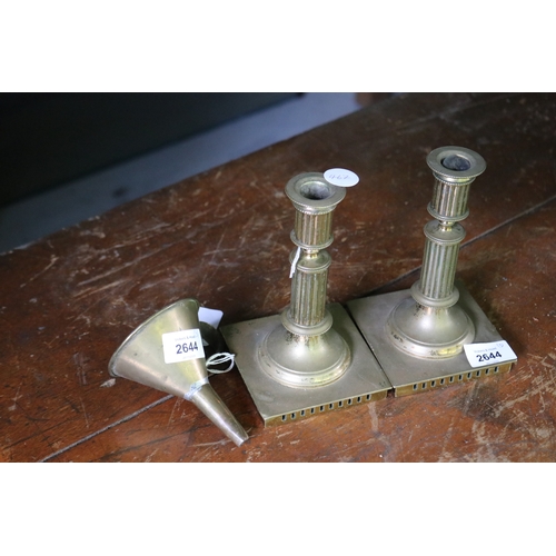 2644 - Pair of cast brass candlesticks along with a small copper funnel, approx 17cm H and shorter (3)