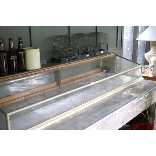 2660 - Antique slope front nickel plated brass shop display cabinet, approx 32cm H x 197cm W x 61cm D