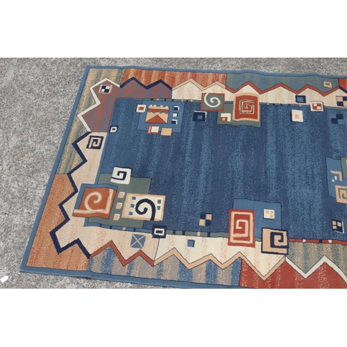 2344 - Handwoven blue ground carpet, approx 171cm x 231cm