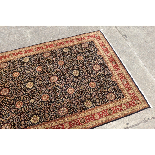 2348 - Fine hand knotted wool Persian carpet, with central royal blue field with all over flower heads and ... 