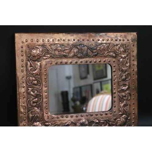 2408 - Arts & Crafts embossed copper framed mirror, approx 38cm x 42cm