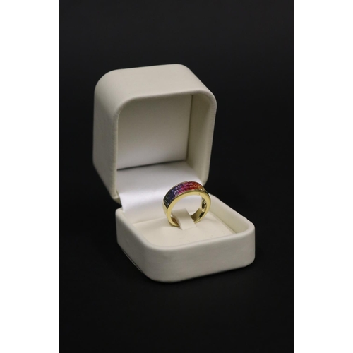 2424 - 18ct yellow gold ring set with Parti coloured sapphires in a rainbow pattern, in original box. Purch... 