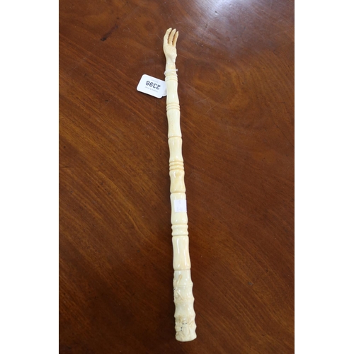 2398 - Carved sectional bone back scratcher, approx 43cm L