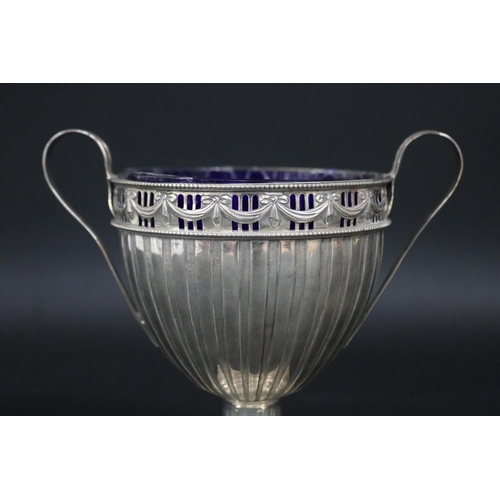 458 - Sterling silver pedestal twin handled cup, approx 15cm H x 17cm W and approx 315 grams excluding gla... 