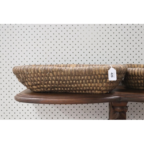 426 - Set of three woven fibre baskets, approx 8cm H x 49cm W x 25cm D and smaller (3)