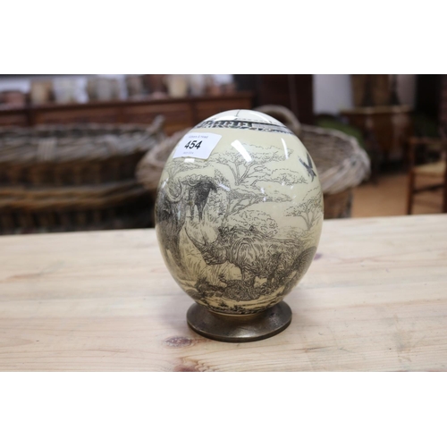 454 - African ostrich egg, decorated with lion, buffalo, rhino, elephant etc, on stand, approx 17cm H