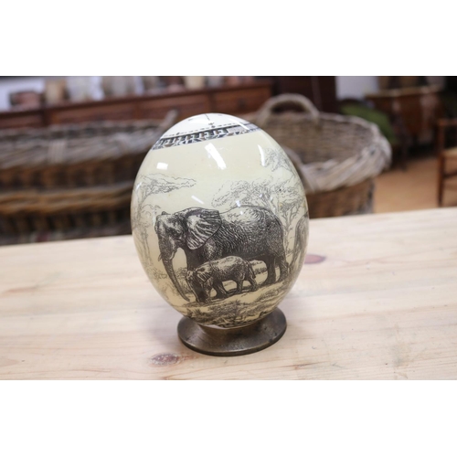 454 - African ostrich egg, decorated with lion, buffalo, rhino, elephant etc, on stand, approx 17cm H