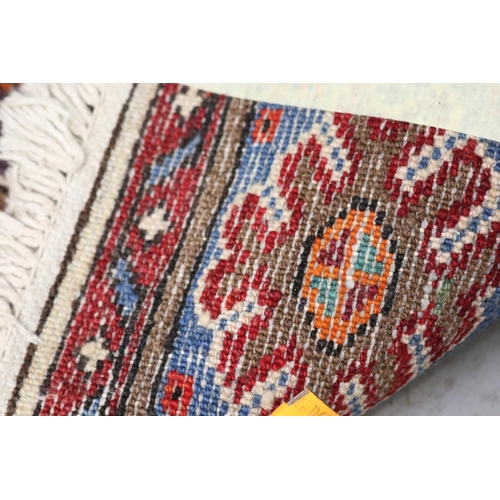 259 - Hand woven wool carpet, approx 128cm x 210cm