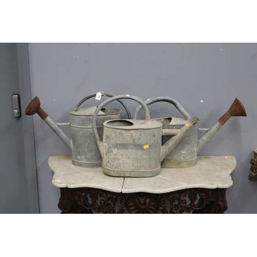 446 - Three French rustic gal metal watering cans, approx 38cm H x 63cm W and smaller (3)