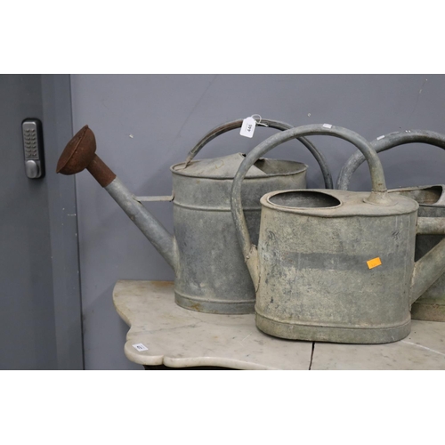 446 - Three French rustic gal metal watering cans, approx 38cm H x 63cm W and smaller (3)