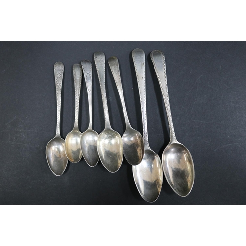 1057 - Seven bright cut hallmarked sterling silver spoons, various dates and makers, approx 130 grams & app... 