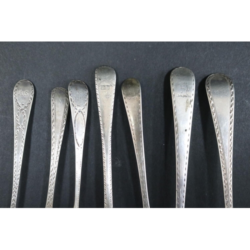 1057 - Seven bright cut hallmarked sterling silver spoons, various dates and makers, approx 130 grams & app... 
