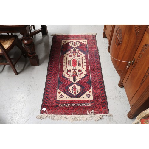 236 - Handwoven red ground wool rug, approx 84cm x 175cm