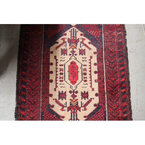 236 - Handwoven red ground wool rug, approx 84cm x 175cm