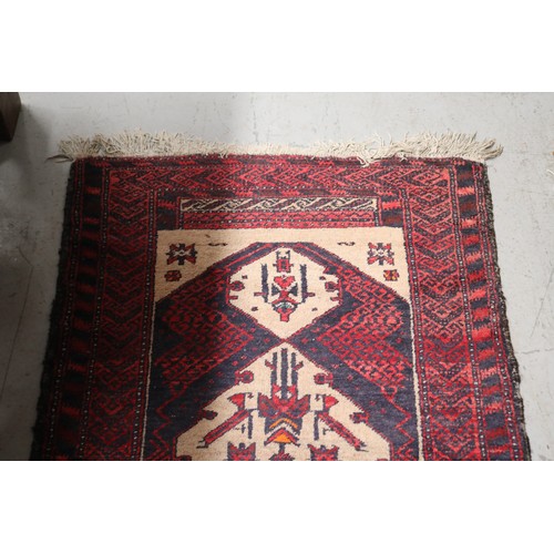 236 - Handwoven red ground wool rug, approx 84cm x 175cm