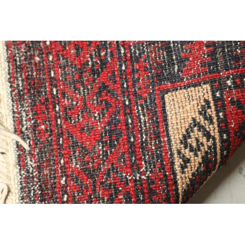 236 - Handwoven red ground wool rug, approx 84cm x 175cm