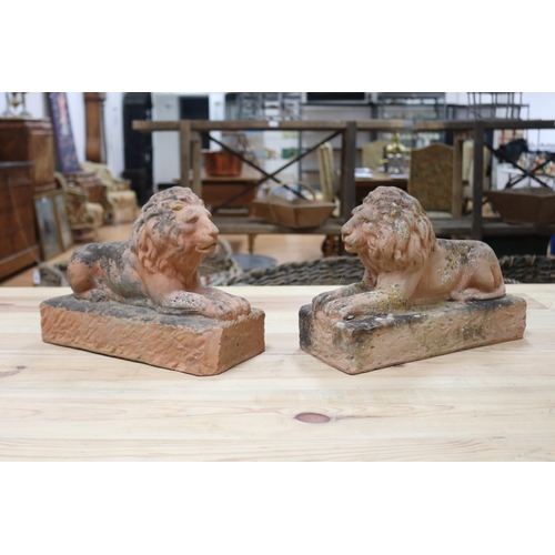 62 - Pair of terracotta garden lions, both seated on plinth, each approx 25cm H x 34cm L (2)
