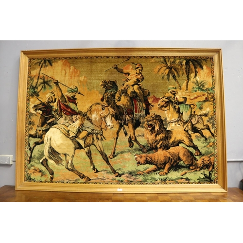 206 - Large framed velour work panel, of Arabs on camel and horse back hunting lions, approx 112cm x 168cm