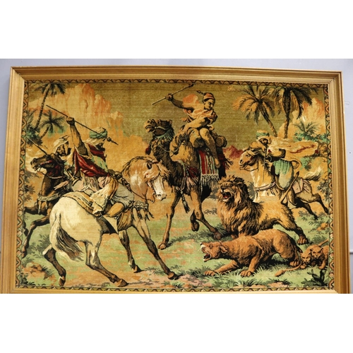 206 - Large framed velour work panel, of Arabs on camel and horse back hunting lions, approx 112cm x 168cm