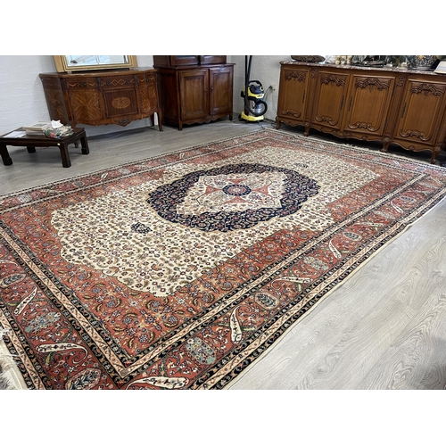 38 - Large Iranian wool carpet, 20th century, hand knotted wool, ivory field with a herati ground, centra... 