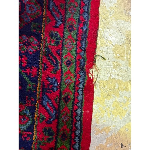 59 - Large Turkoman red ground carpet, hand knotted wool, central field of Ejder designs guls in alternat... 
