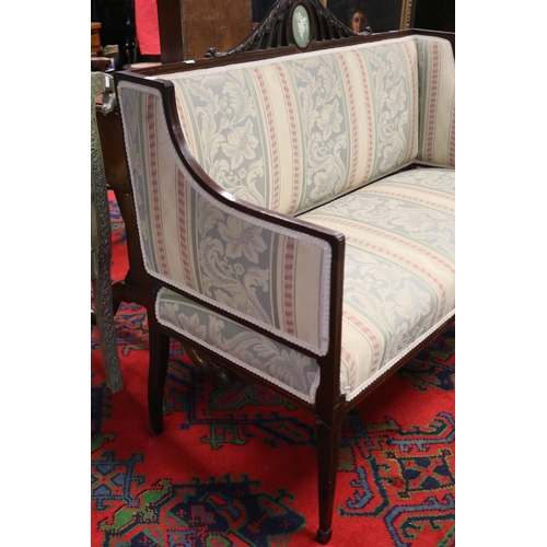 60 - Petit Sheraton revival inlaid rosewood two seater settee, the carved pierced back crest set with an ... 