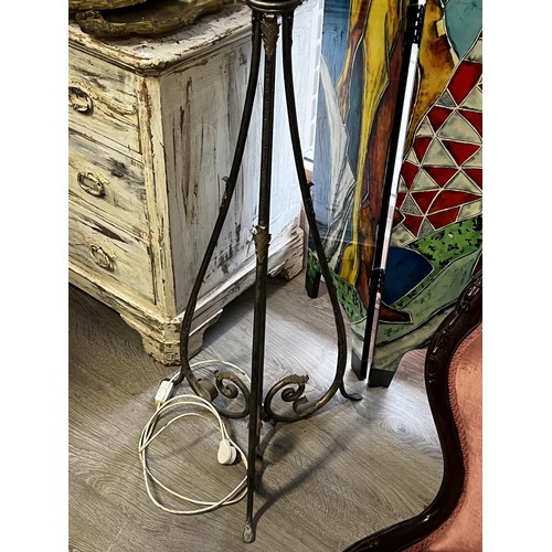 444 - Elaborate wrought iron tri form support standard lamp, with metal encased glass shade, applied scrol... 